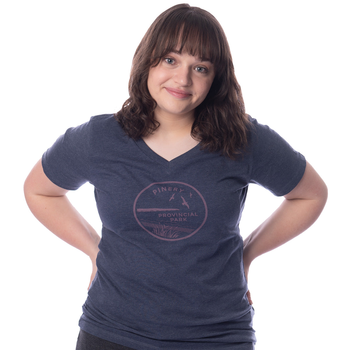 Female wearing heather navy Ladies Fit Park Specific T-shirt V-neck. Pink Pinery park crest on centre chest.