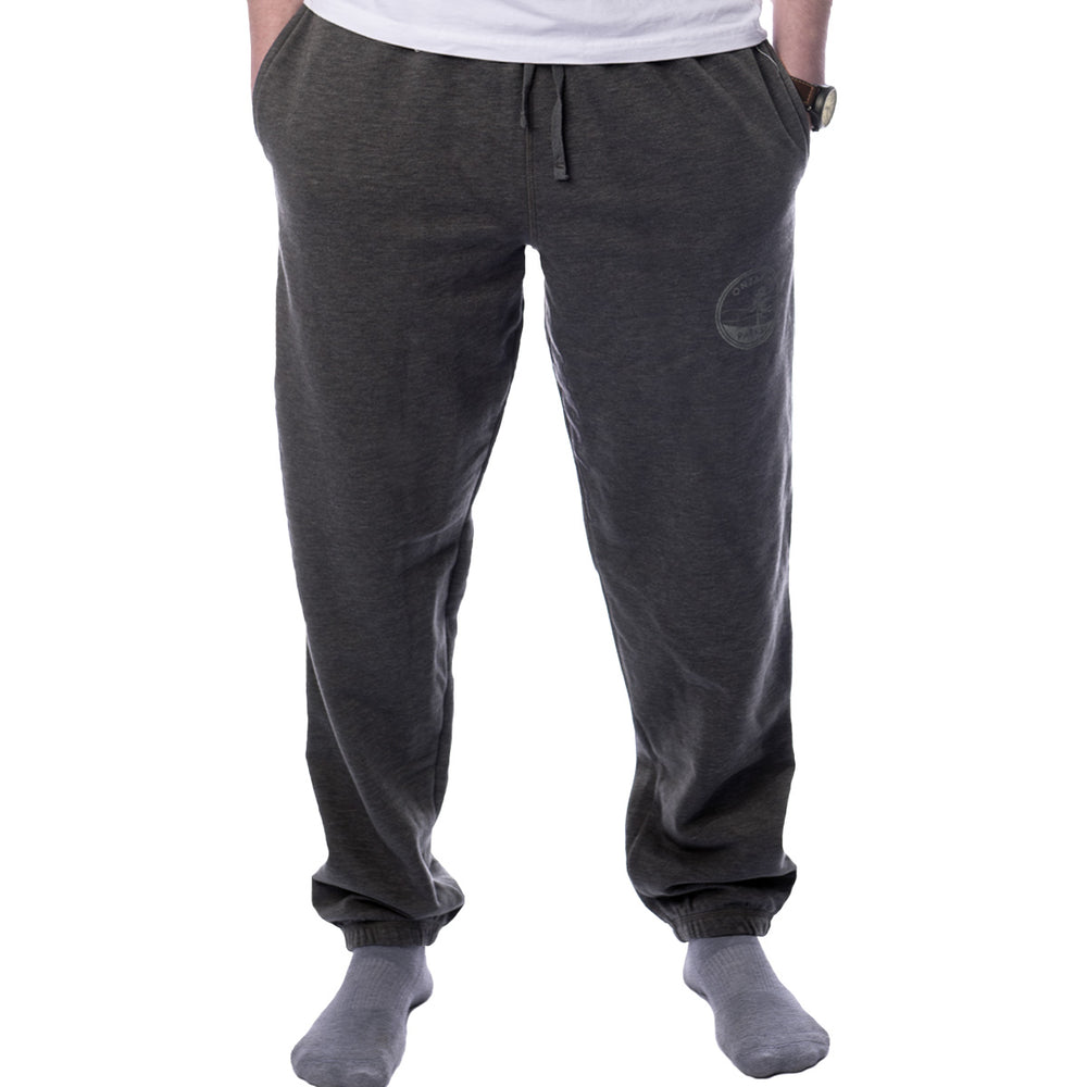 Male wearing Sport Grey Unisex Ontario Parks Crest Sweatpants. Ontario Parks crest imprinted on top of left thigh.