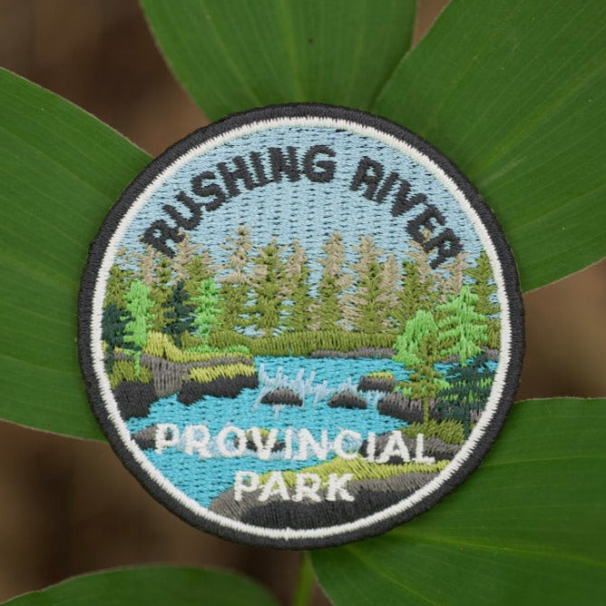 Round embroidered park crest patch for Rushing River Provincial Park