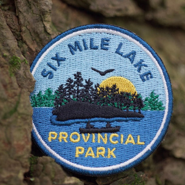 Round embroidered park crest patch for Six Mile Lake Provincial Park