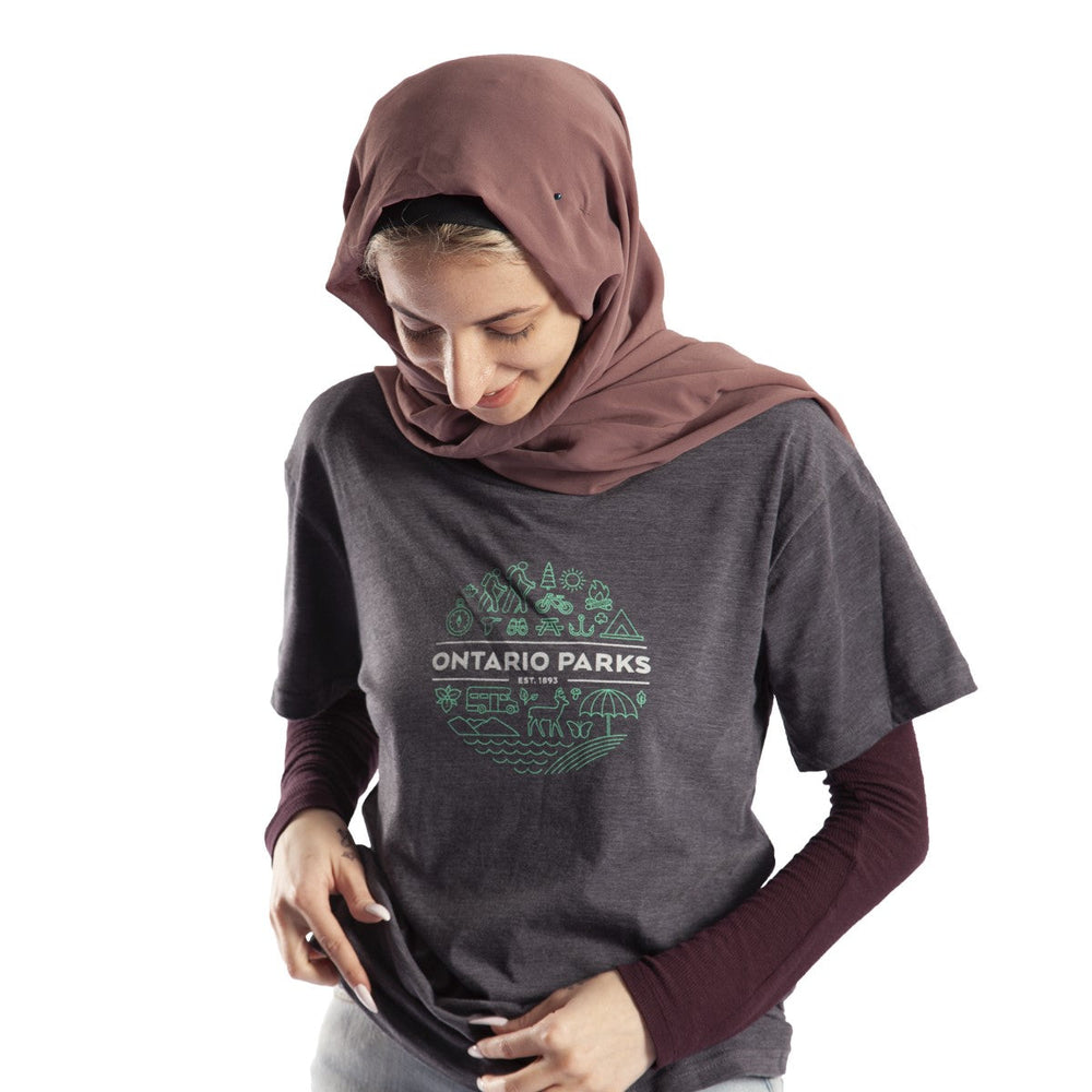 Female wearing grey South T-shirt. Green/white 'South' design screened on centre chest.